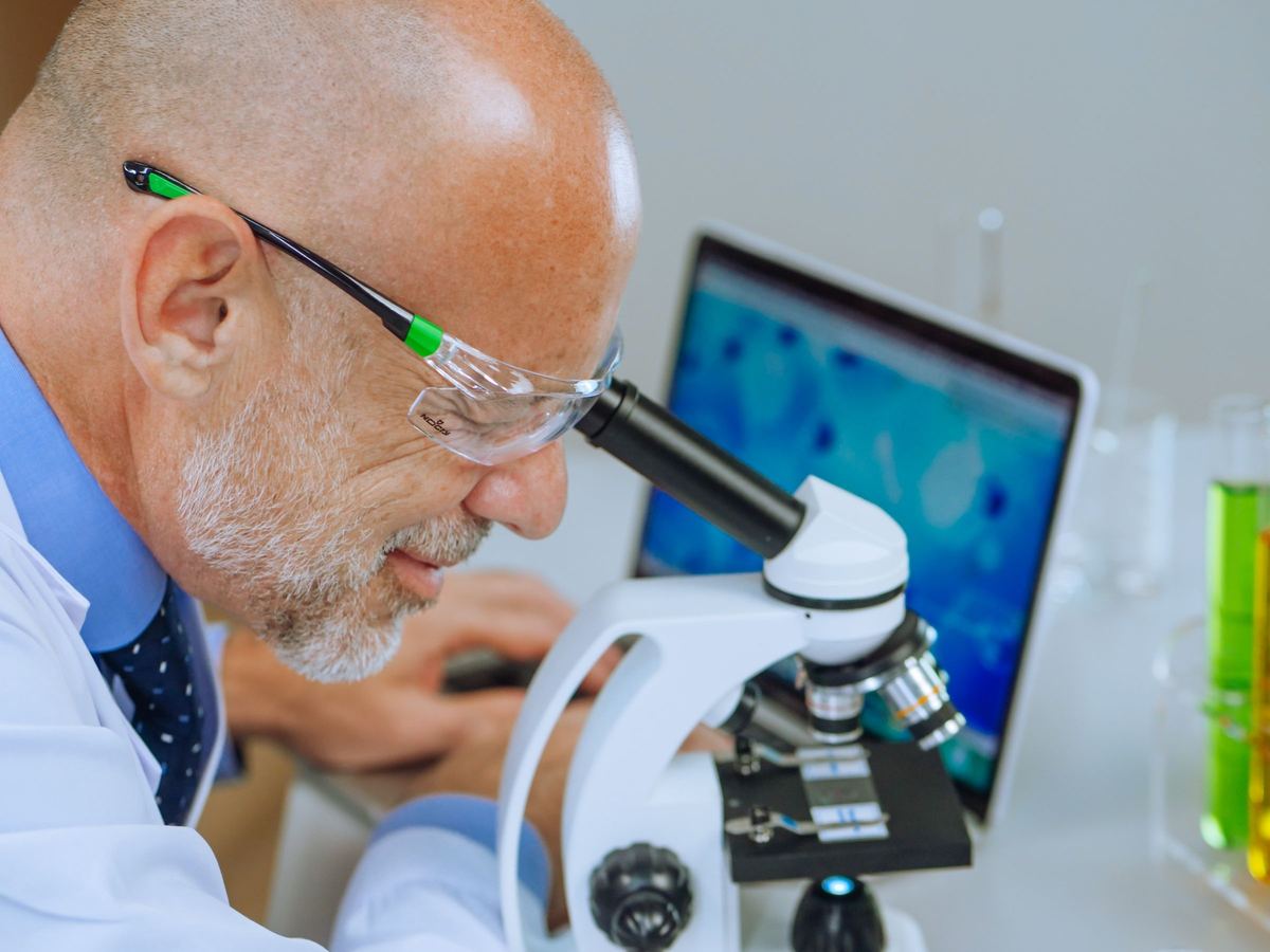 Researcher running automated TEM image analysis at a microscope workstation