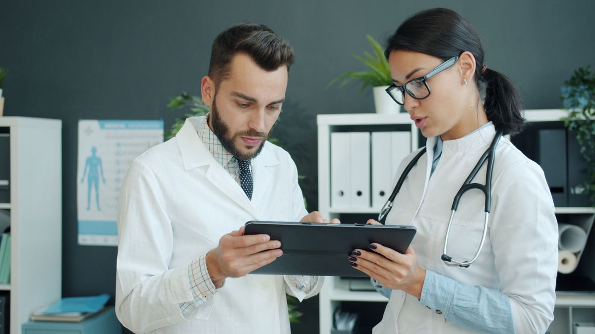 Clinician and participant reviewing study data on a tablet