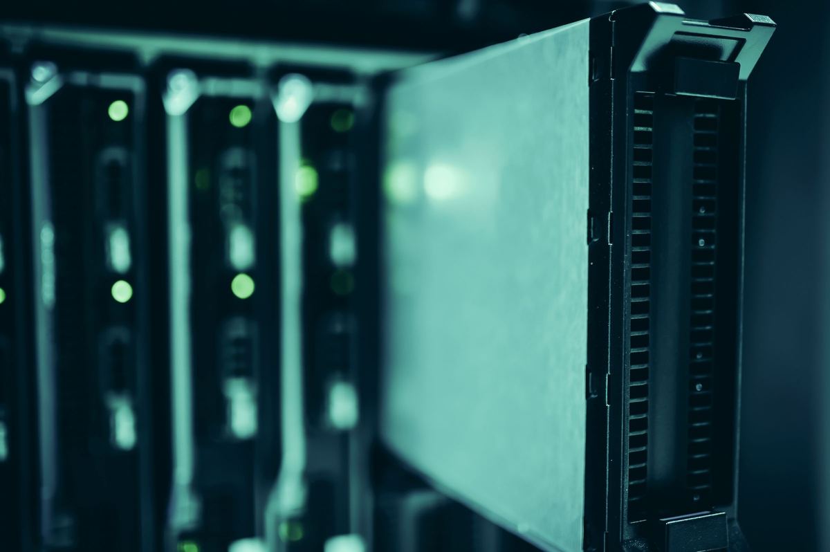 Data center aisle overlaid with a cloud and connected device diagram