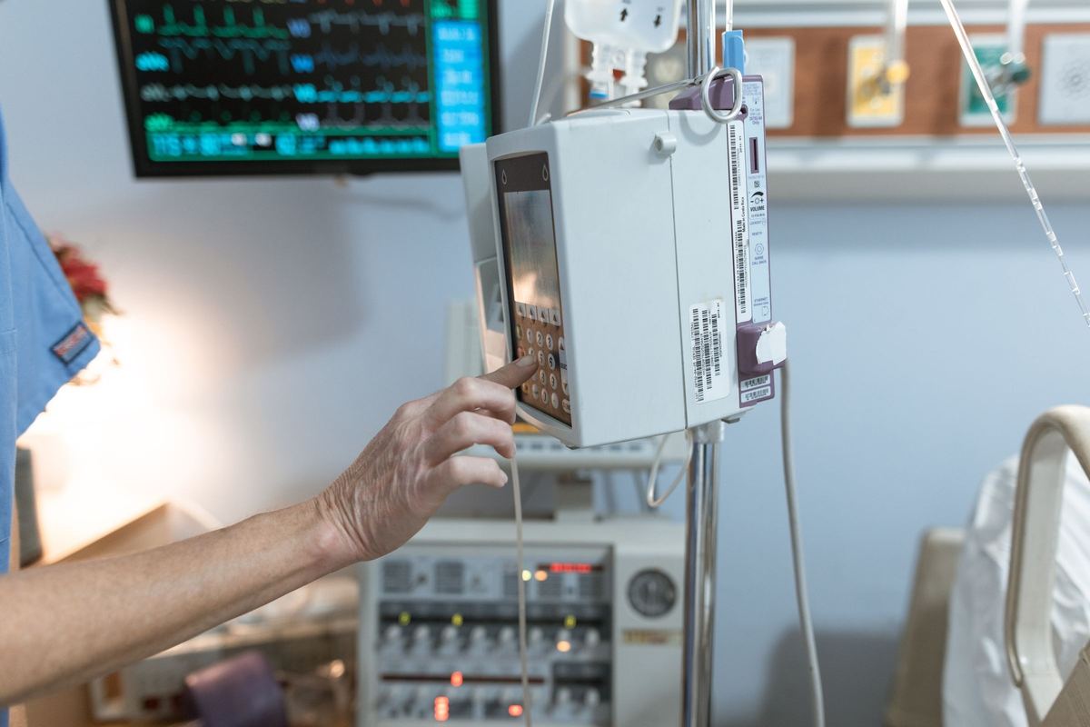 Clinical analyzer control panel showing patient results beside a connected information system
